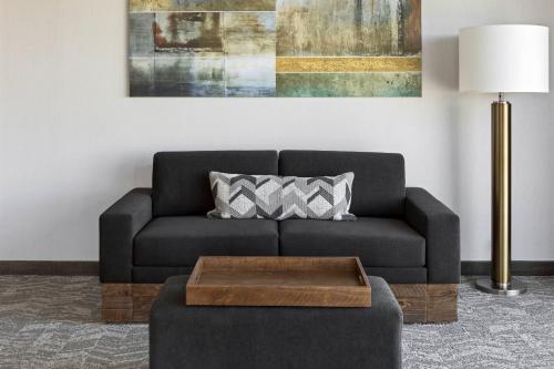 a living room with a couch and a table at SpringHill Suites by Marriott Greenville Downtown in Greenville