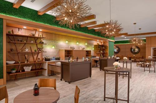 a large room with tables and chairs in a store at SpringHill Suites by Marriott Greenville Downtown in Greenville