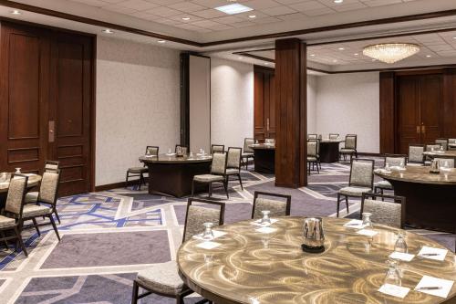 a conference room with tables and chairs and a podium at Sheraton Indianapolis City Centre Hotel in Indianapolis