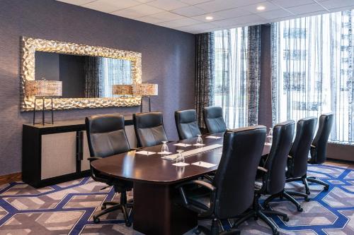 a conference room with a table and chairs and a mirror at Sheraton Indianapolis City Centre Hotel in Indianapolis