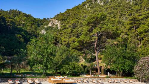 a group of tables and chairs in front of a mountain at Yazz Collective in Fethiye