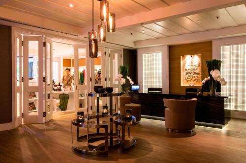 a salon with a table and chairs in a room at The Ritz-Carlton, Kuala Lumpur in Kuala Lumpur