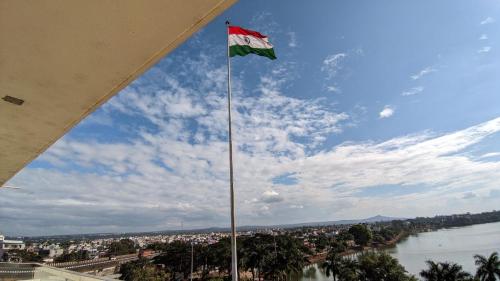 a flag flying on top of a building next to a river at Mayur Belgaum Presidency Hotel & Spa in Belgaum