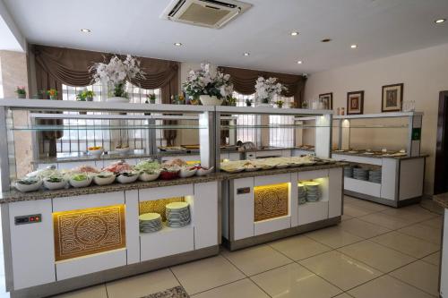a buffet in a restaurant with food on display at Kandelor Hotel in Alanya