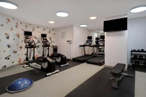 a gym with several tread machines and a flat screen tv at SpringHill Suites by Marriott New York Midtown Manhattan/Park Ave in New York