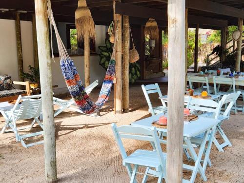 a group of chairs and hammocks on a beach at Barrinha dos Ventos Barrinha de Baixo Ceara Quartos Casas Kitesurf in Acaraú