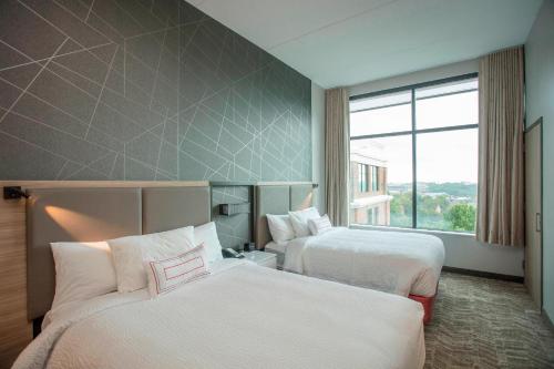 a hotel room with two beds and a window at Springhill Suites By Marriott Athens Downtown/University Area in Athens
