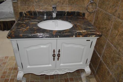 a bathroom sink with a marble counter top at Greens Manor VI in Lagos