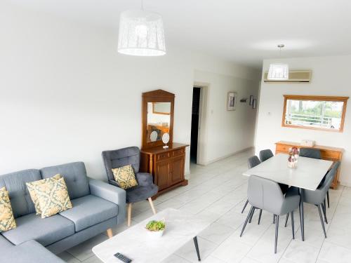 a living room with a couch and a table at Samos City Center, 2BR Sleeps 4 in Limassol