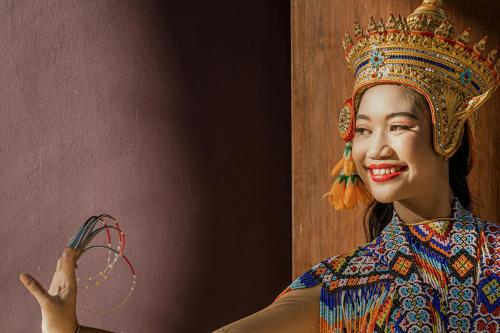 a woman wearing a crown holding a string at Phulay Bay, A Ritz-Carlton Reserve in Tab Kaek Beach
