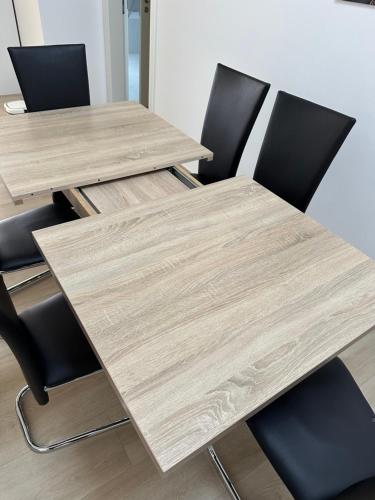 a wooden table and chairs in an office at Große Ferienwohnung Gästehaus NEUBAU Merzig 120m2 in Merzig