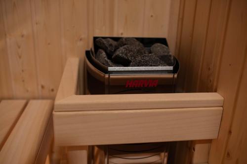 a box of grey rocks in a wooden cabinet at Apartman Crni bor 2 Tara in Kaludjerske Bare