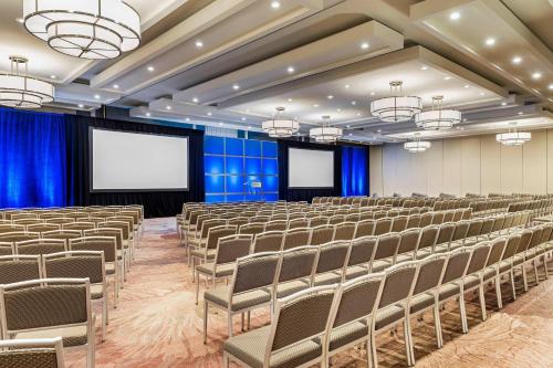 a conference room with chairs and a screen at The Westin Toronto Airport in Toronto