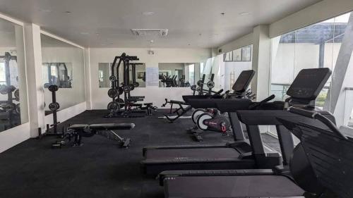 a gym with several treadmills and exercise bikes at 803 - Quiet Condo in City Centre in Davao City