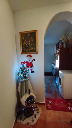 a room with a christmas tree and a santa claus wall at B&B La Casa D Ju Nan in Bussi sul Tirino