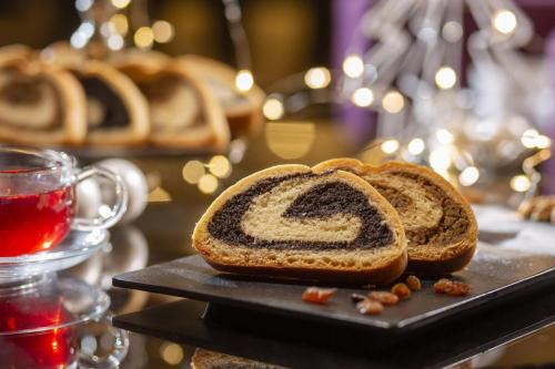a loaf of bread on a plate next to a cup of tea at The Westin Zagreb in Zagreb
