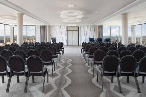 a conference room with black chairs and a podium at The Westin Zagreb in Zagreb