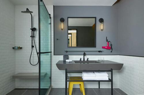 a bathroom with a sink and a mirror at Moxy Shanghai Xuhui in Shanghai