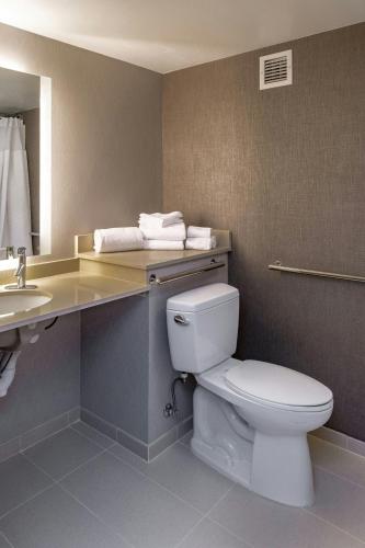 a bathroom with a toilet and a sink at SpringHill Suites Anchorage Midtown in Anchorage