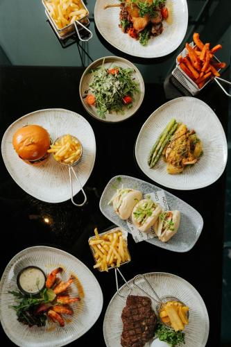a bunch of plates of food on a table at W London in London