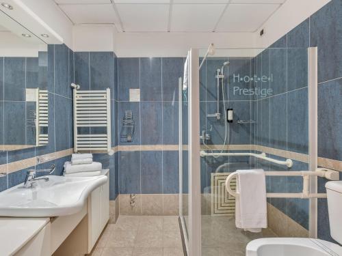 a bathroom with a toilet sink and a shower at B&B HOTELS Hotel Prestige Ornago in Ornago
