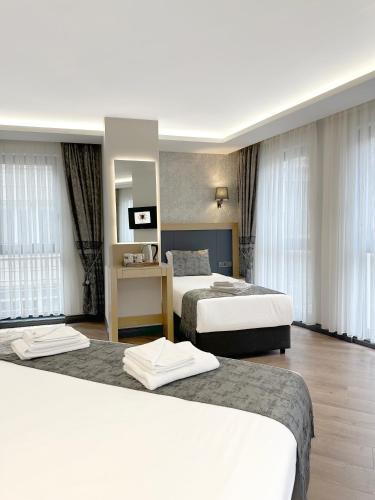 a hotel room with two beds and a mirror at Gulec Hotel & Spa - Special Category in Istanbul