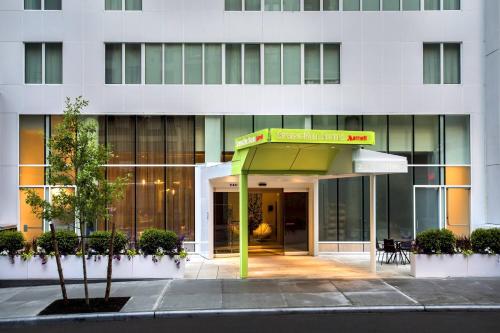 a building with a green canopy in front of it at SpringHill Suites by Marriott New York Midtown Manhattan/Fifth Avenue in New York