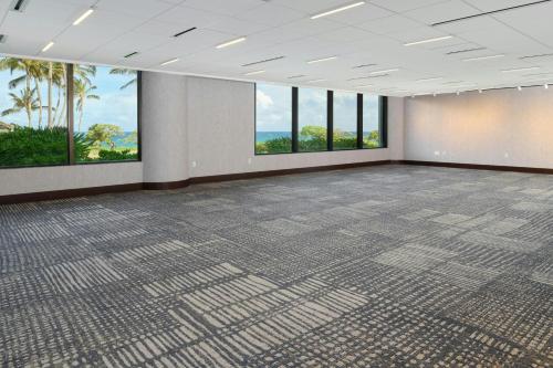 an empty room with a large room with windows at The Ritz-Carlton O'ahu, Turtle Bay in Kahuku