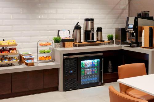 a drink station in a restaurant with a refrigerator at Kansas City Airport Marriott in Kansas City