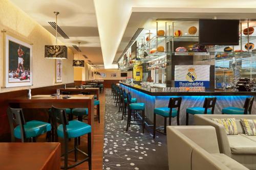 a bar with blue chairs in a restaurant at Le Meridien Cairo Airport in Cairo