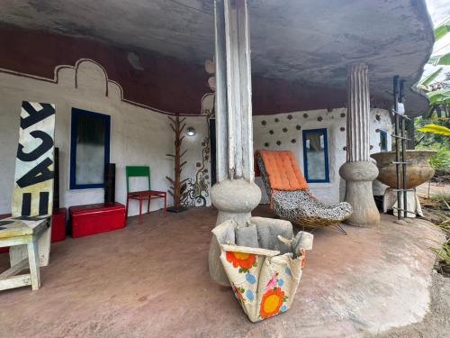 a living room with a couch and chairs at Clay House Chiang Mai By Alphatel in Chiang Mai
