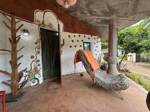 a porch with a hammock in front of a house at Clay House Chiang Mai By Alphatel in Chiang Mai