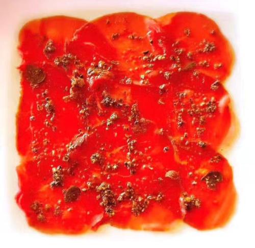 a close up of a red fruit with sauce at Tenuta Del Gallo in Amelia