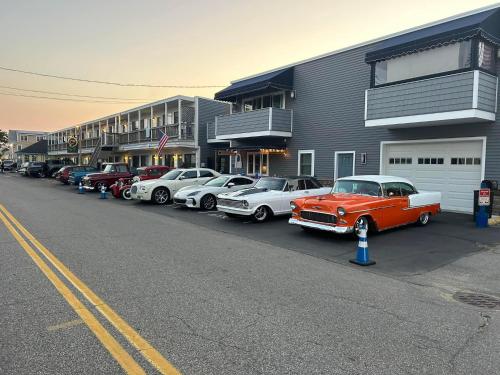 a row of cars parked in front of a building at Seagrass Inn in Old Orchard Beach