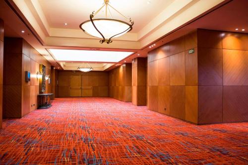 an empty hallway of a building with a chandelier at Sheraton Pilar Hotel & Convention Center in Pilar