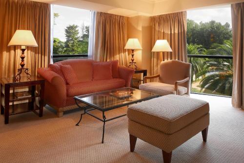 a living room with a couch and a table and chairs at Sheraton Pilar Hotel & Convention Center in Pilar