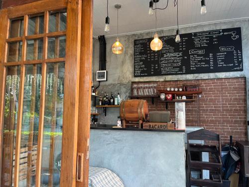 a bar with a chalkboard on a brick wall at Cha-am , Twin Bed Room , Naer Cha-am Beach South in Ban Bo Khaem