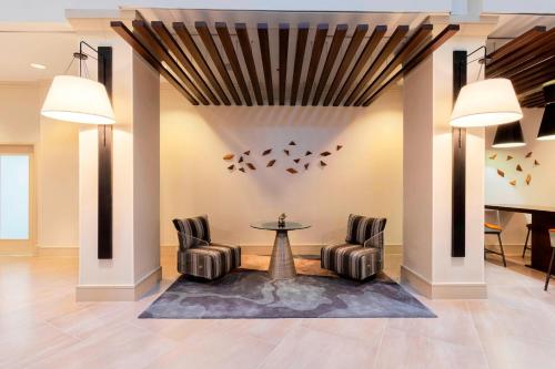 a lobby with chairs and a table and a piano at Atlanta Marriott Northeast/Emory Area in Atlanta
