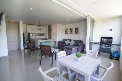 a living room with a table and chairs and a couch at Santa fe de Antioquia apartamento vacacional di sole 1306 in Santa Fe de Antioquia