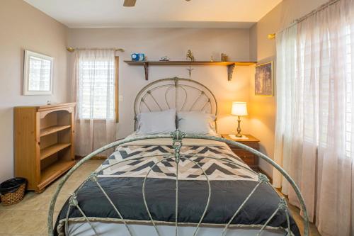a bedroom with a bed with a metal frame at Cool Breeze Cabin in Black Man Eddy