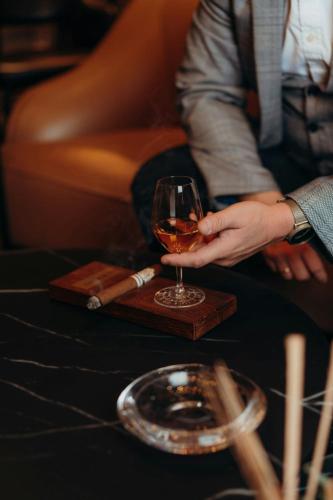 a person holding a glass of wine on a table at The Ritz-Carlton, Berlin in Berlin
