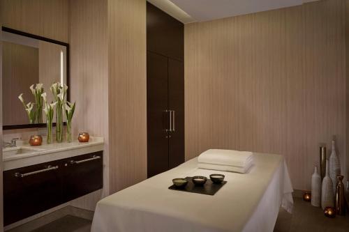 a bathroom with a bed with a sink and a mirror at The Ritz-Carlton, Berlin in Berlin