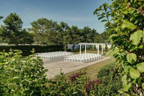 a row of white chairs in a garden at Sheraton Eatontown Hotel in Eatontown