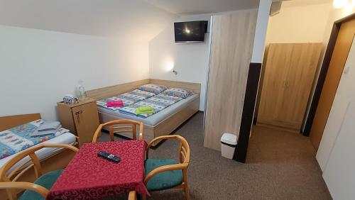 a small room with a bed and a table and chairs at Pension 444 - Ski Resort Herlikovice and Bubakov in Vrchlabí