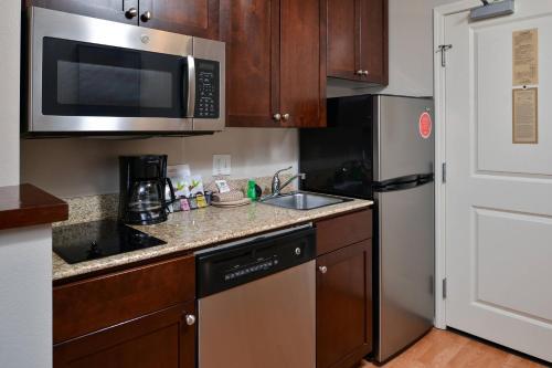 a kitchen with a sink and a microwave at TownePlace Suites by Marriott Boise Downtown/University in Boise