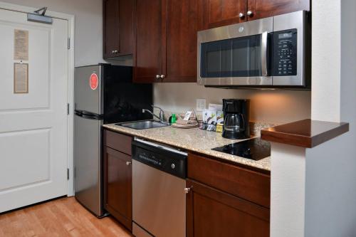 a kitchen with a sink and a microwave at TownePlace Suites by Marriott Boise Downtown/University in Boise