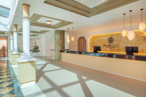 a lobby of a hotel with a reception counter at AluaSoul Costa Adeje - Adults Only in Adeje