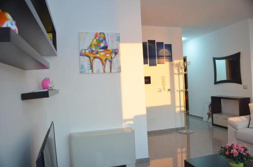 a living room with a couch and a painting on the wall at Home Sweet Home by the Sea - 060 in Durrës