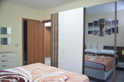a bedroom with a mirror and a bed and a dresser at Home Sweet Home by the Sea - 060 in Durrës