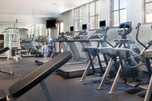 a gym with rows of treadmills and machines at La Posada De Santa Fe, a Tribute Portfolio Resort & Spa in Santa Fe